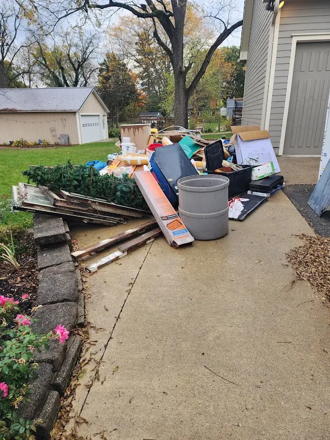 Dumpster being loaded with debris for Estate Cleanout Dumpster Rental in Lake Mathews